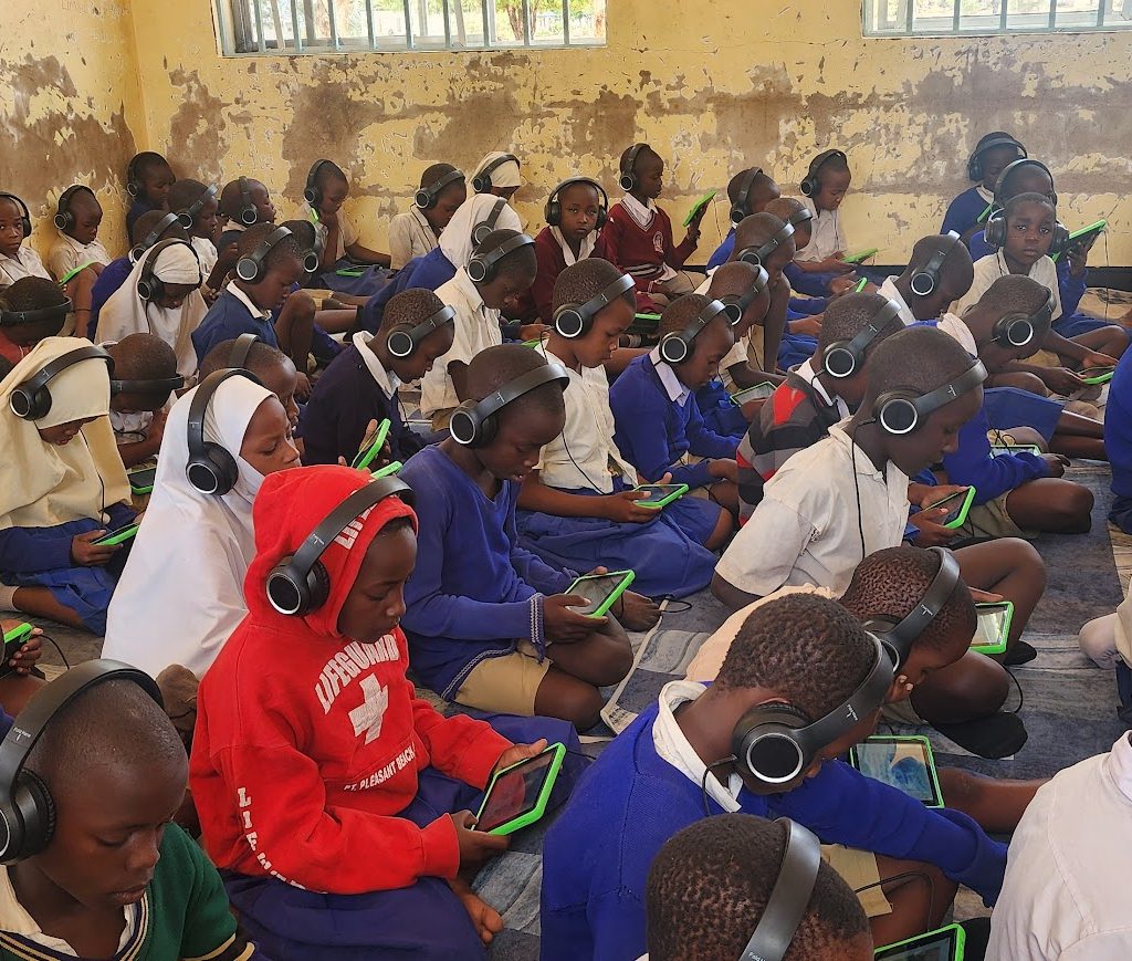 Tanzanian children using tablets for digital learning through the Imagine World TZ and Camara Education TZ project