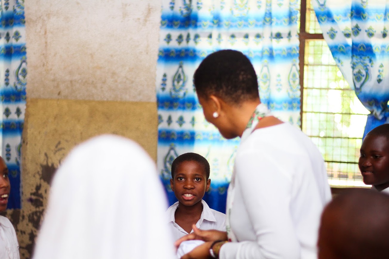 Teacher supporting students through safeguarding and child protection practices in Tanzania