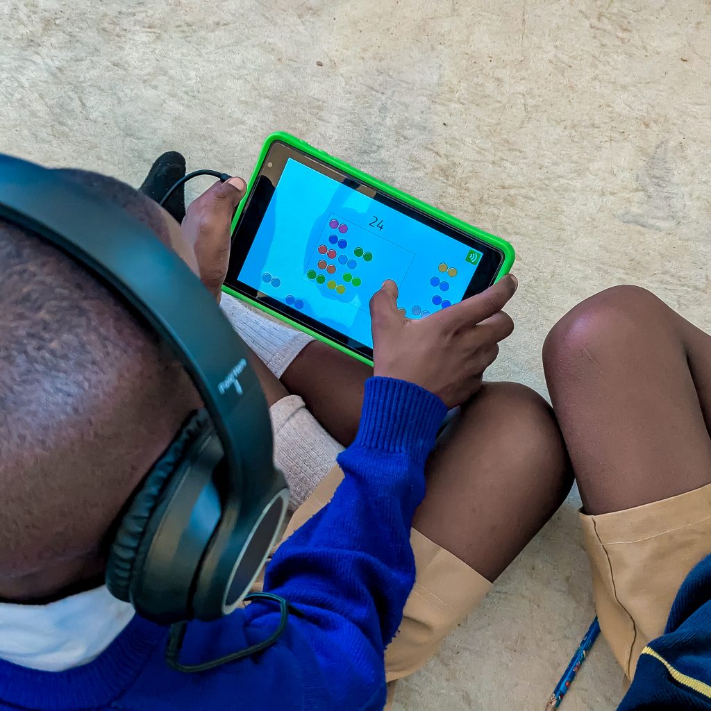Primary school student using a tablet for digital learning at Didia Primary School in Tanzania supported by Camara Education Tanzania